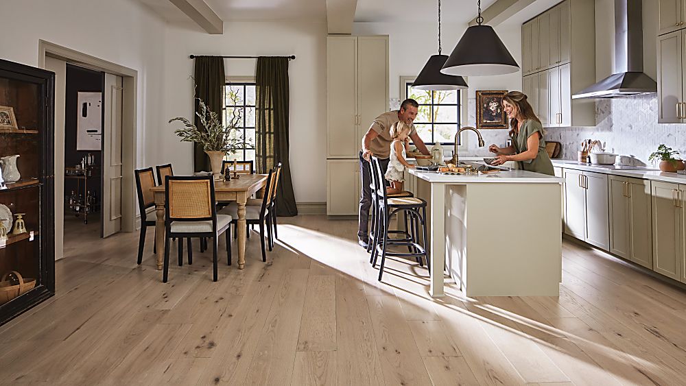 Light oak hardwood flooring in an open-concept kitchen and dining area